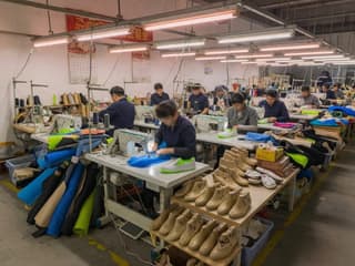 Footwear factory production with sewing stations and shoe components